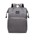 Foldable Baby Bed carry bag in gray Oxford cloth with top handles, shoulder straps, and a large front zip pocket