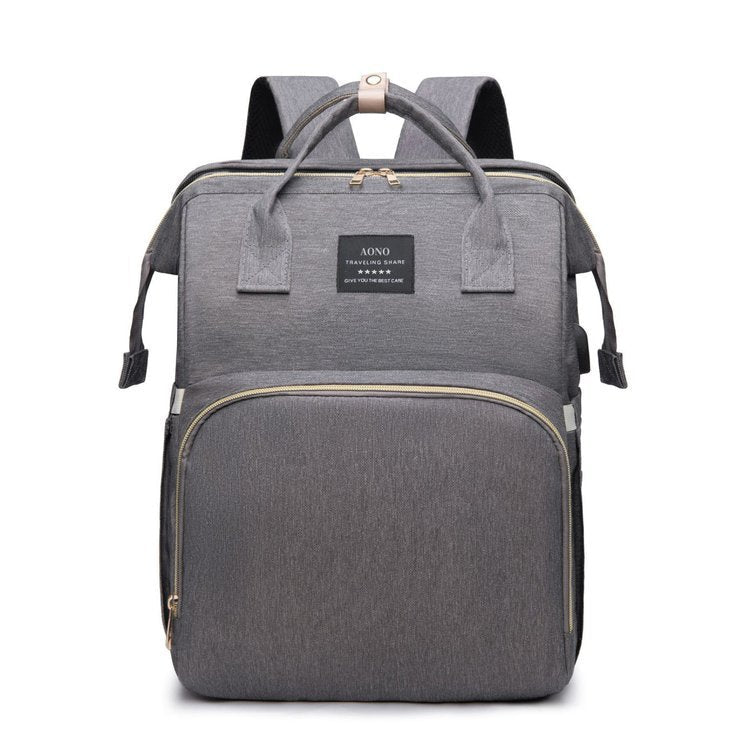 Foldable Baby Bed carry bag in gray Oxford cloth with top handles, shoulder straps, and a large front zip pocket