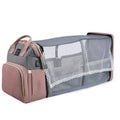 Foldable Baby Bed in gray and dusty pink Oxford fabric, with a zippered carry bag and lace-trimmed mesh mosquito net.