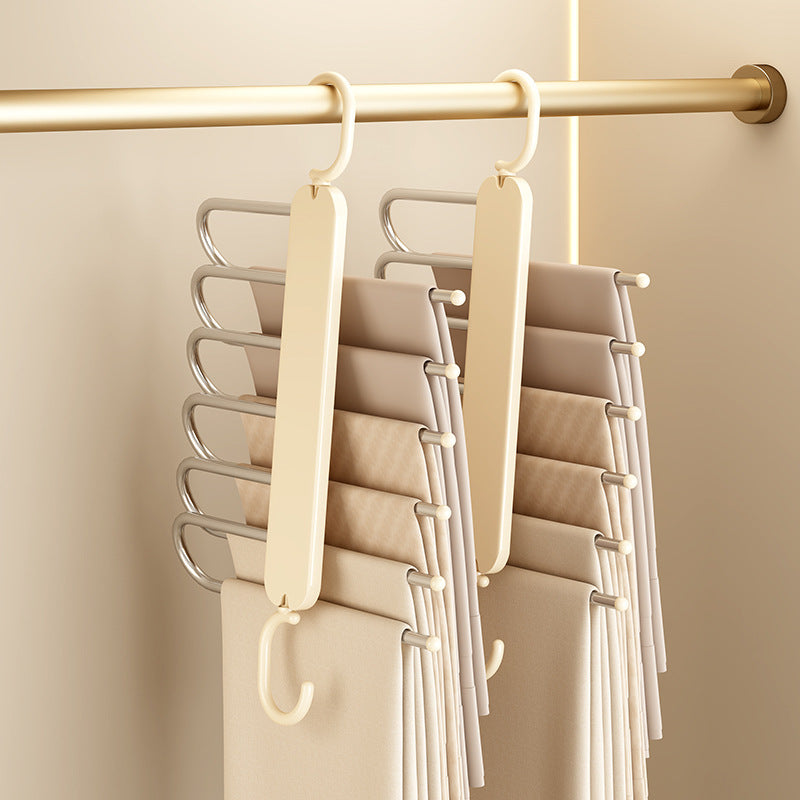 Foldable Multi-layer Pants Hanger with cream-colored plastic frame and silver metal bars, featuring a 90-degree rotating hook.