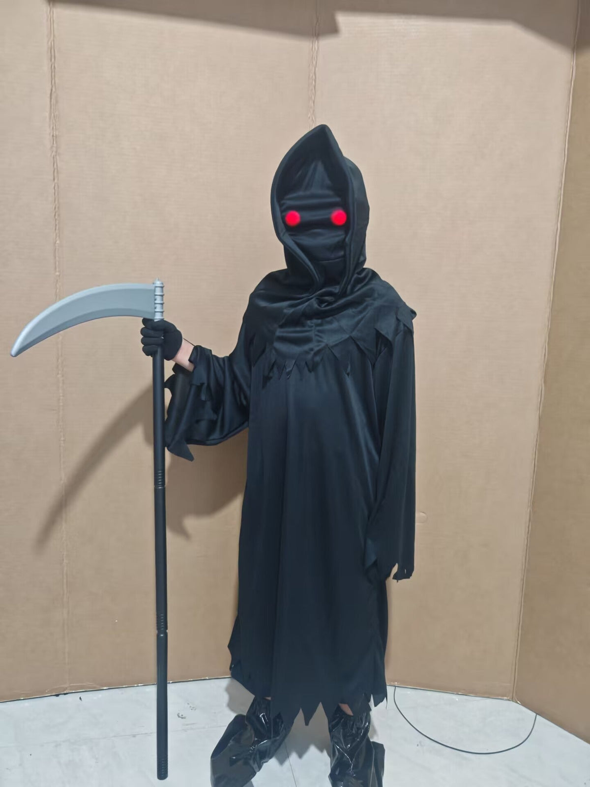 Glow-in-the-Dark Halloween Skeleton Costume with a black hooded robe, glowing red eyes, and a silver scythe prop