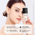 Goddess Beauty Pure Beauty liquid foundation bottle with black cap, white and blush pink packaging, shown beside a model