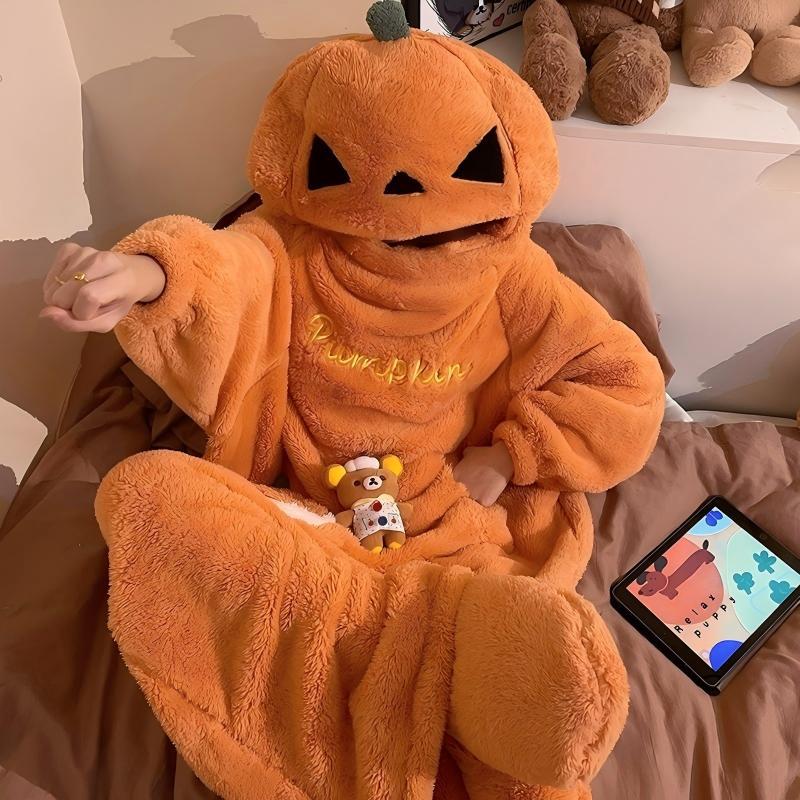 Halloween Cartoon Coral Fleece jumpsuit in plush orange, featuring a hood with a black jack-o’-lantern face and pumpkin accents.
