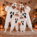 Halloween Ghost Plush Pajamas in soft white fleece, featuring hooded one-piece suits with black oval ghost faces for adults and children.
