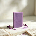 Herbal soap bar in muted purple with a smooth, speckled surface and clean rectangular shape
