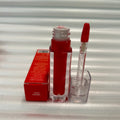 Huda Beauty Moisturizing lip gloss in vivid cherry red, with a clear rectangular tube and matching doe-foot applicator