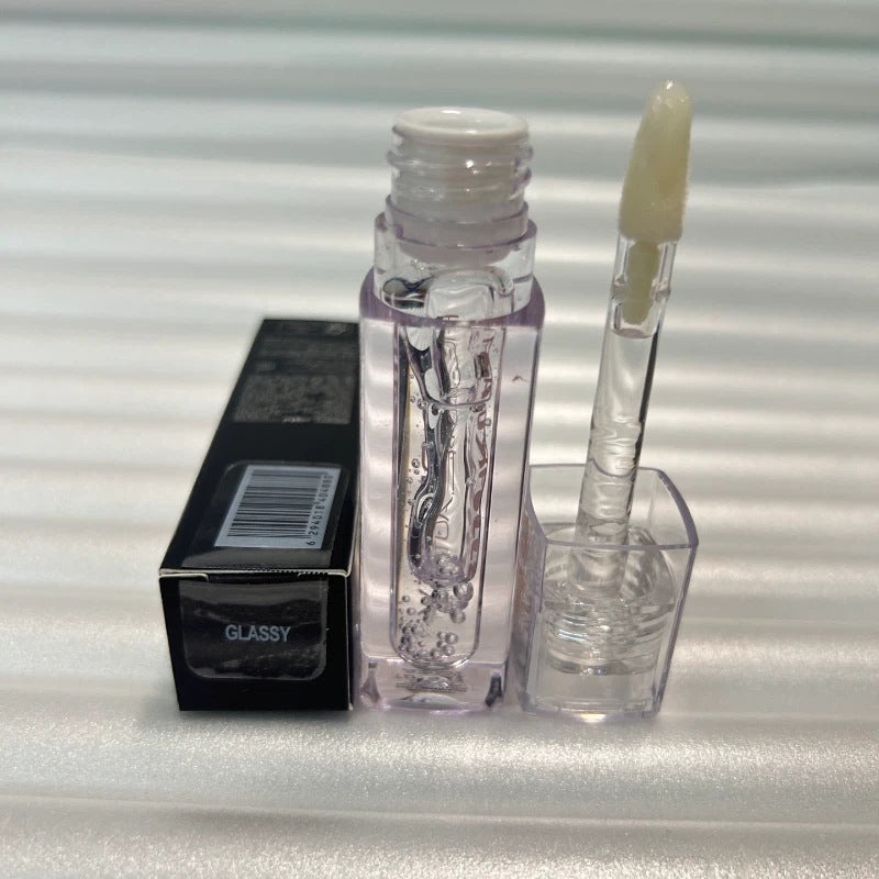 Huda Beauty Moisturizing lip gloss in a clear tube with a transparent applicator and glossy finish