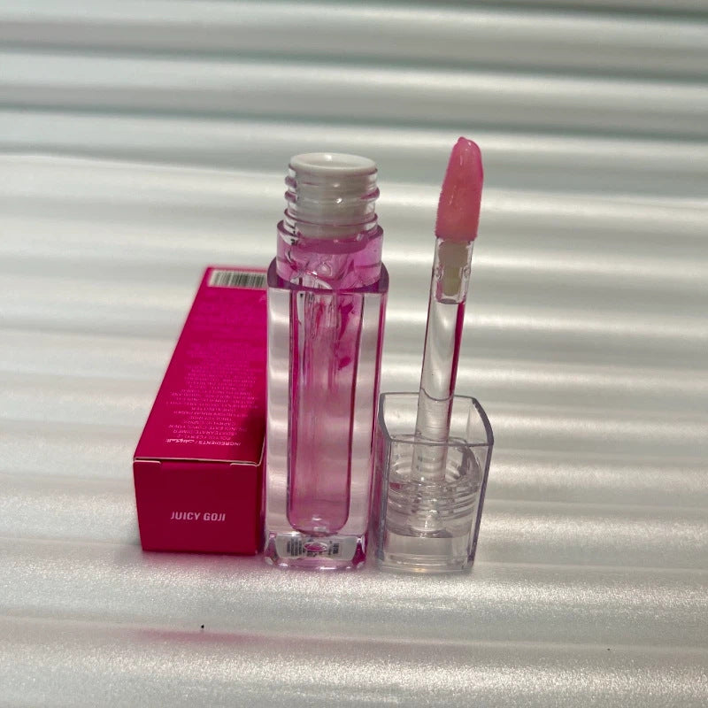 Huda Beauty Moisturizing lip gloss in a clear rectangular tube with bright pink accents and a pink doe-foot applicator