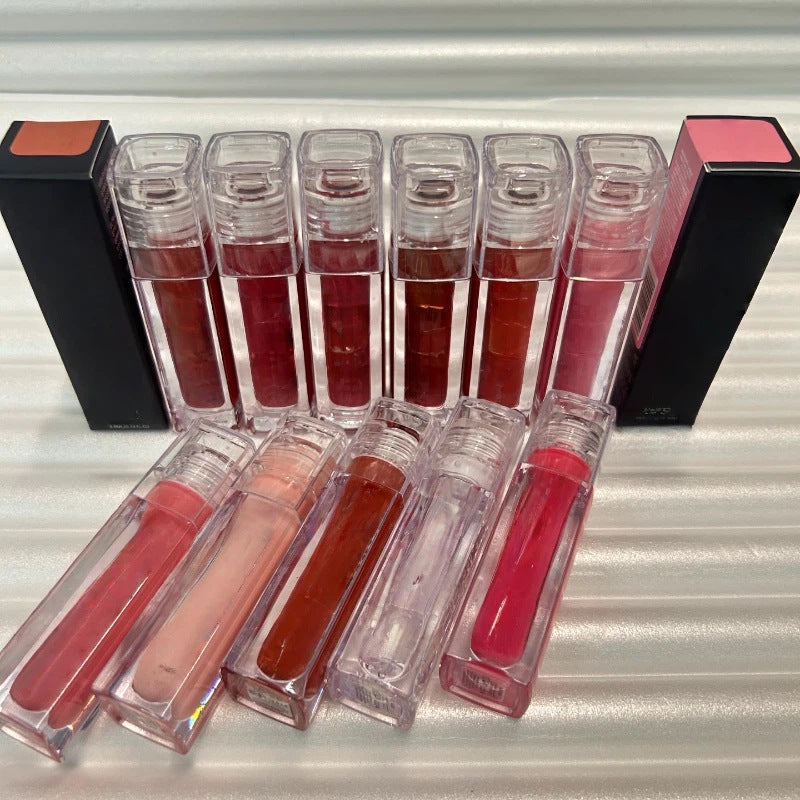Huda Beauty Moisturizing lip gloss set with clear rectangular tubes in assorted rosy, nude, red and brown shades