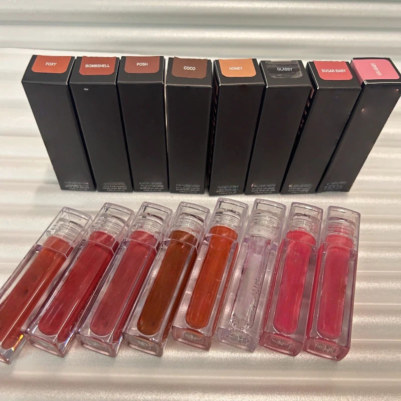 Huda Beauty Moisturizing lip glosses in clear rectangular tubes, with black boxes and a range of red, pink, nude and brown shades