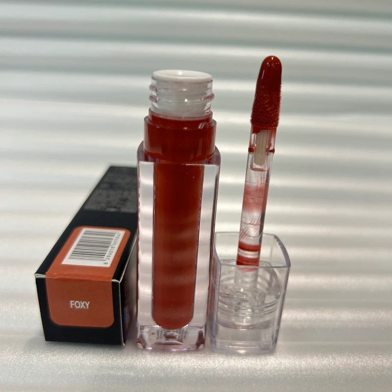 Lip gloss in a clear rectangular tube with deep reddish-brown color and matching doe-foot applicator, Huda Beauty Moisturizing