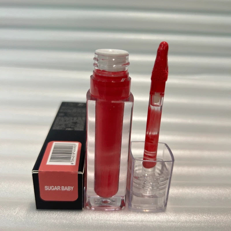 Huda Beauty Moisturizing lip gloss in a clear tube with vivid red color, matching applicator and Sugar Baby box