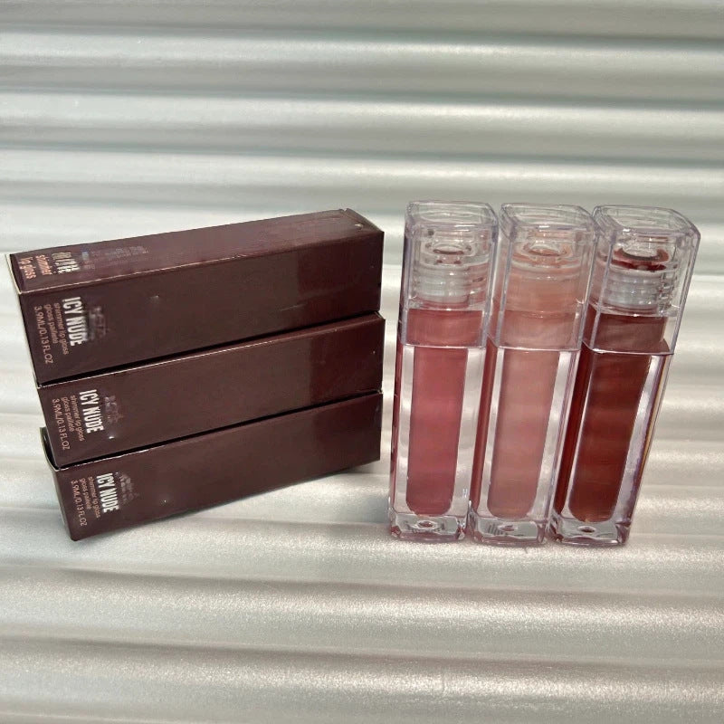 Huda Beauty Moisturizing lip gloss set in clear rectangular tubes, showing assorted pink, red, nude and brown shades with glossy color labels.