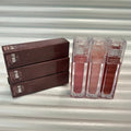 Huda Beauty Moisturizing lip glosses in clear rectangular tubes, showing three shades of rosy pink, nude, and deep brown.