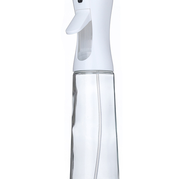Kitchen Oil Spray Bottle with a clear glass body and white plastic pump, featuring a trigger-style spray nozzle.