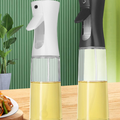 Kitchen Oil Spray Bottle with a clear glass reservoir, yellow oil, and white or black press-spray top.