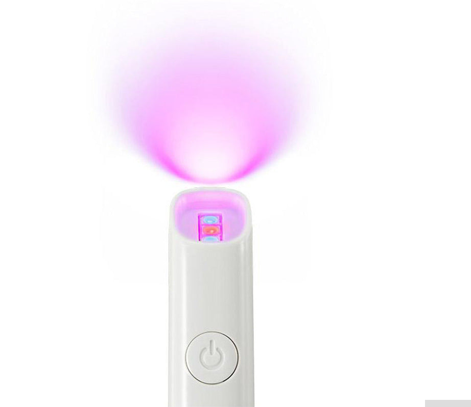 LED acne treatment pen with a white cylindrical body, round power button and glowing pink-purple LED tip; LED Red Blue Light technology.
