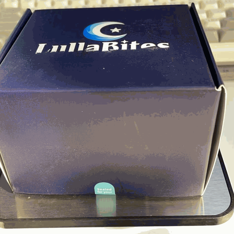 Lulla Bites Sleep Gummies box in dark navy and gray, featuring a crescent moon and star logo with white lettering