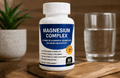 Magnesium Complex Capsules in a white bottle with a navy label, orange badge, and 60-capsule count