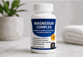 Magnesium Complex Capsules in a white bottle with a navy label, orange badge and 60-capsule count