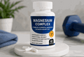 Magnesium Complex Capsules in a white bottle with a navy label, yellow badge, and 60-count marking beside white capsules