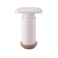 Manual Vacuum Food hand pump with a white cylindrical body, broad press handle and contrasting brown base.
