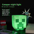 Minecraft Ore lamps include a glowing green Creeper night light with a pixelated face and cube-shaped design