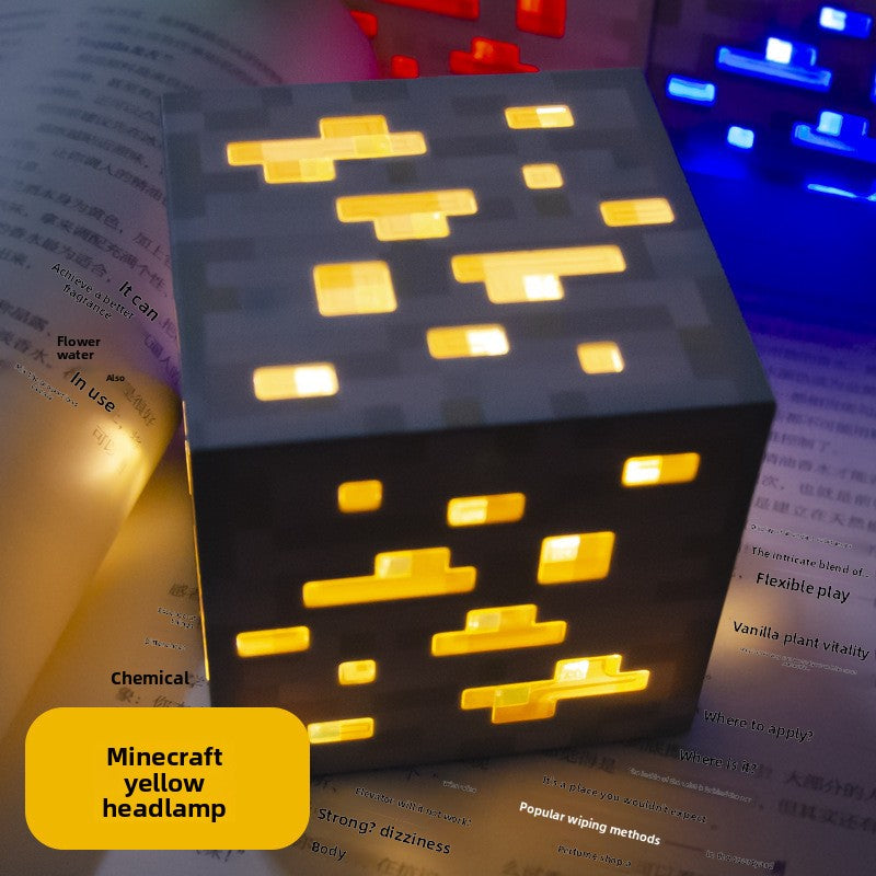Minecraft Ore lamps yellow cube lamp with glowing golden pixel blocks and a dark gray ore pattern on each face