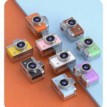 Miniature Digital Camera in colourful ABS plastic, with a retro compact body, prominent circular lens and small flip screen.