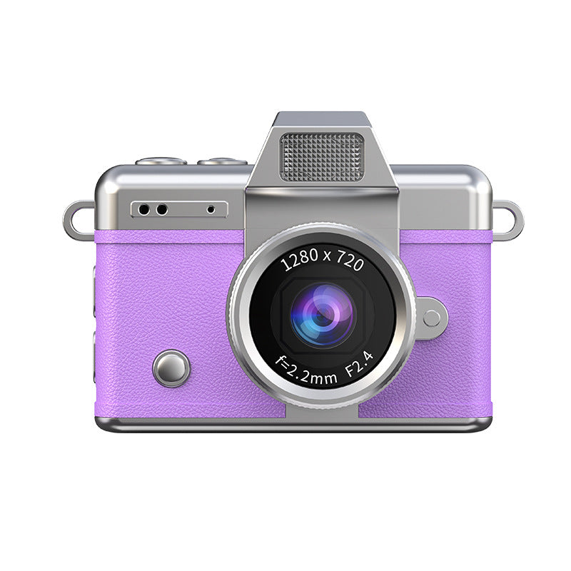 Miniature Digital Camera with a purple textured body, silver trim, central lens, top grille and round front button.