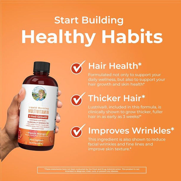 Liquid multivitamin supplement in a dark amber bottle with a red cap, white and orange label, and matching peach mango carton; Multivitamin Hair Vitamin.