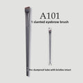 Professional Makeup Brush Set slanted eyebrow brush with slim dark handle, angled bristles, and clear protective tube