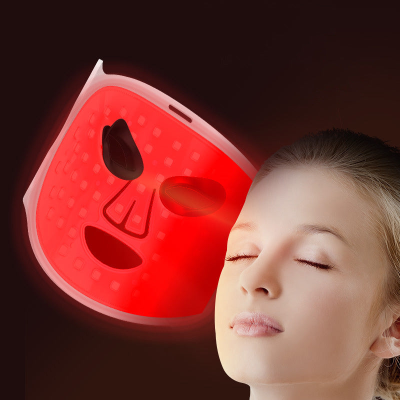 Red Light Therapy Mask with a white contoured face shell, red-trimmed eye openings and fine curved line details