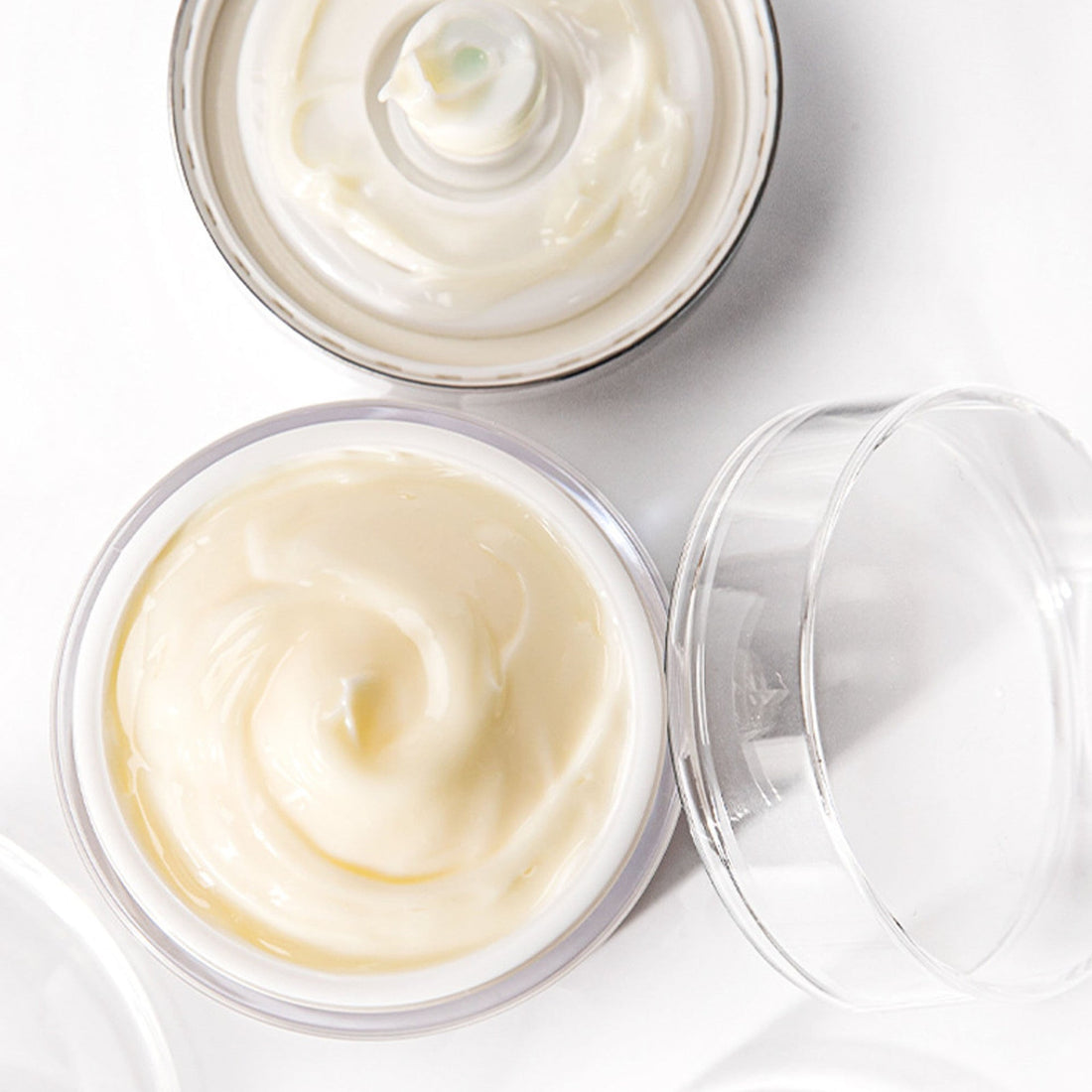 Retinol Vitamin E Anti-Wrinkle moisturizer cream in a clear jar with a silver lid and black band, labeled with retinol details.