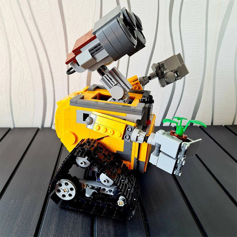 Wall-e Robot Building Blocks feature a block-built robot with a yellow and orange body, gray arms, black treads, and large eyes.