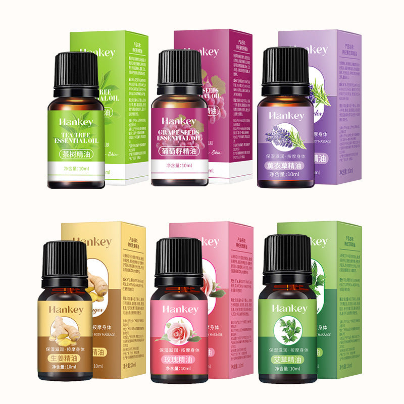 Essential oil set with Rose Ginger Mugwort Massage Essential Oil among six amber bottles, black caps and colorful cartons