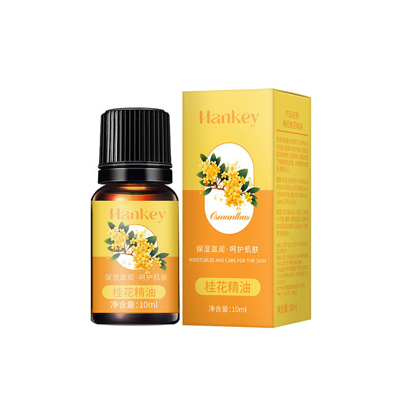 Essential oil bottle with yellow-orange floral packaging and black ribbed cap, showing a osmanthus label; Rose Ginger Mugwort Massage Essential Oil