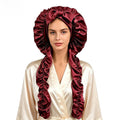 Satin Long Hair Sleeping Bonnet Cap in glossy burgundy satin with a ruffled edge, bow detail, and long protective panels