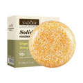 Shampoo Bar with a round amber and cream speckled solid texture, displayed beside a cream and olive-green box