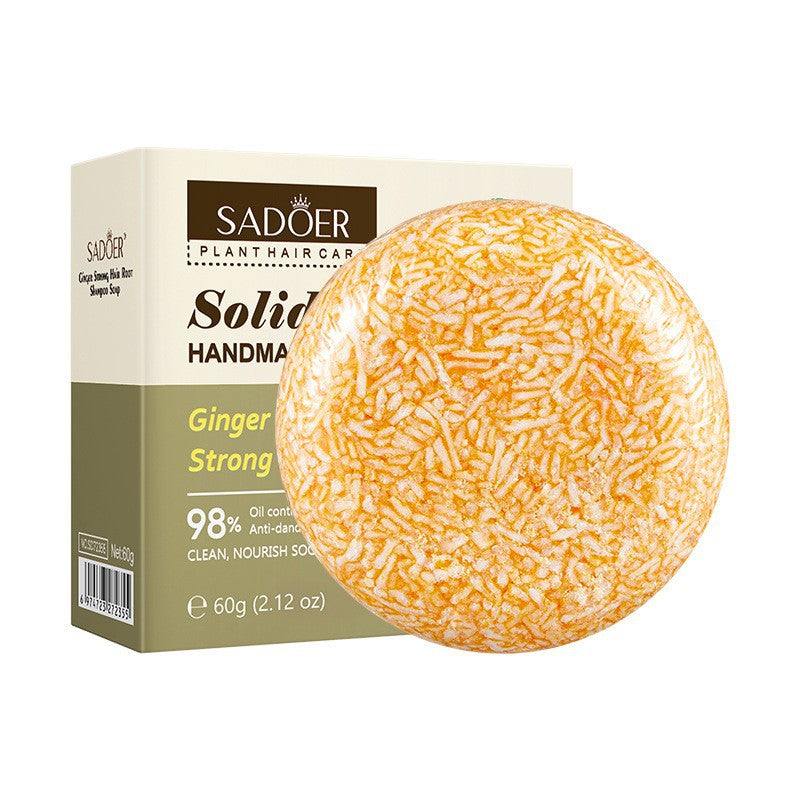Shampoo Bar with a round amber and cream speckled solid texture, displayed beside a cream and olive-green box