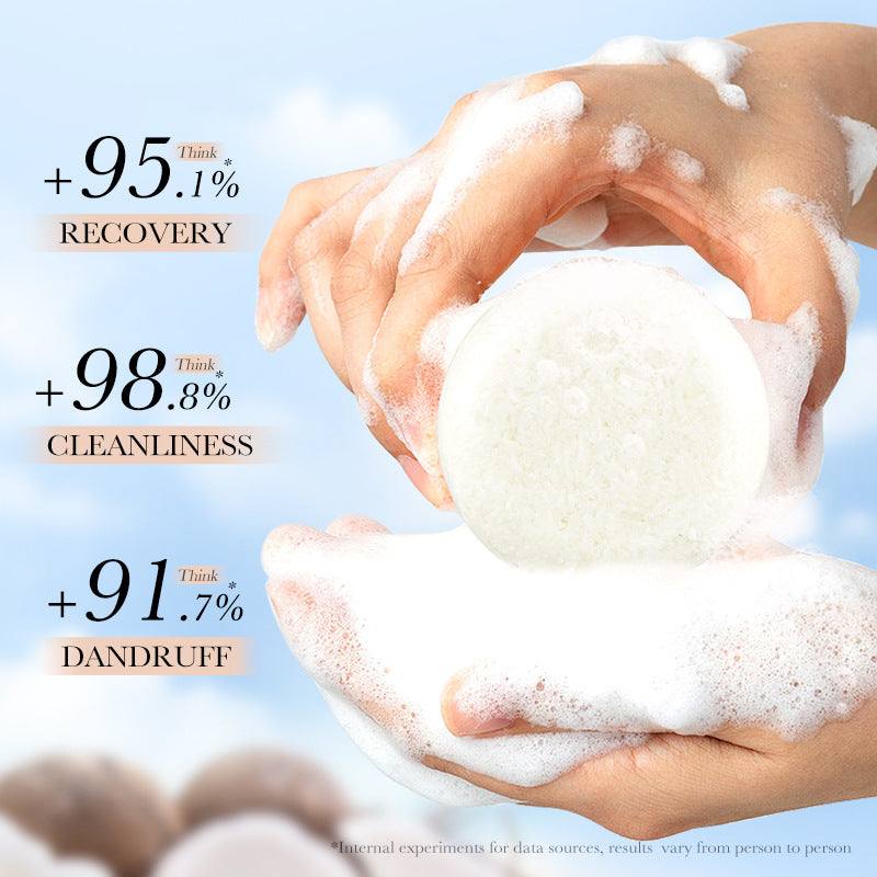 Shampoo Bar, round ivory solid cleanser with a porous surface, held between hands covered in rich white lather
