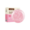 Shampoo Bar, round pink solid bar with a white flecked pattern, displayed beside cream and pink packaging