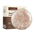 Shampoo Bar with a round tan-and-cream speckled solid surface, shown beside its cream and brown Sadoer product box