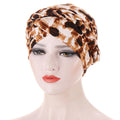 Braided headscarf cap in brown and cream animal print, with a twisted braid detail around the crown; Short braids can be hidden