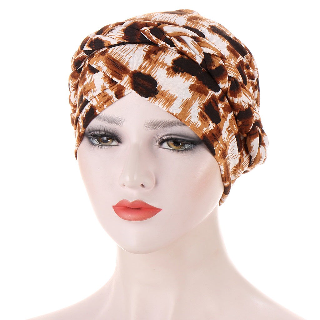 Braided headscarf cap in brown and cream animal print, with a twisted braid detail around the crown; Short braids can be hidden