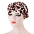 Headscarf cap in brown and cream abstract animal print with braided trim; Short braids can be hidden beneath its soft fabric.