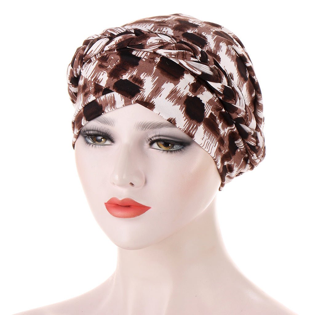 Headscarf cap in brown and cream abstract animal print with braided trim; Short braids can be hidden beneath its soft fabric.
