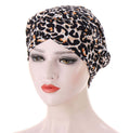 Leopard print headscarf cap in soft fabric with a gathered, turban-style front; Short braids can be hidden beneath it