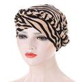 Headscarf cap in beige and black zebra-print polyester, featuring a braided trim; Short braids can be hidden beneath it.