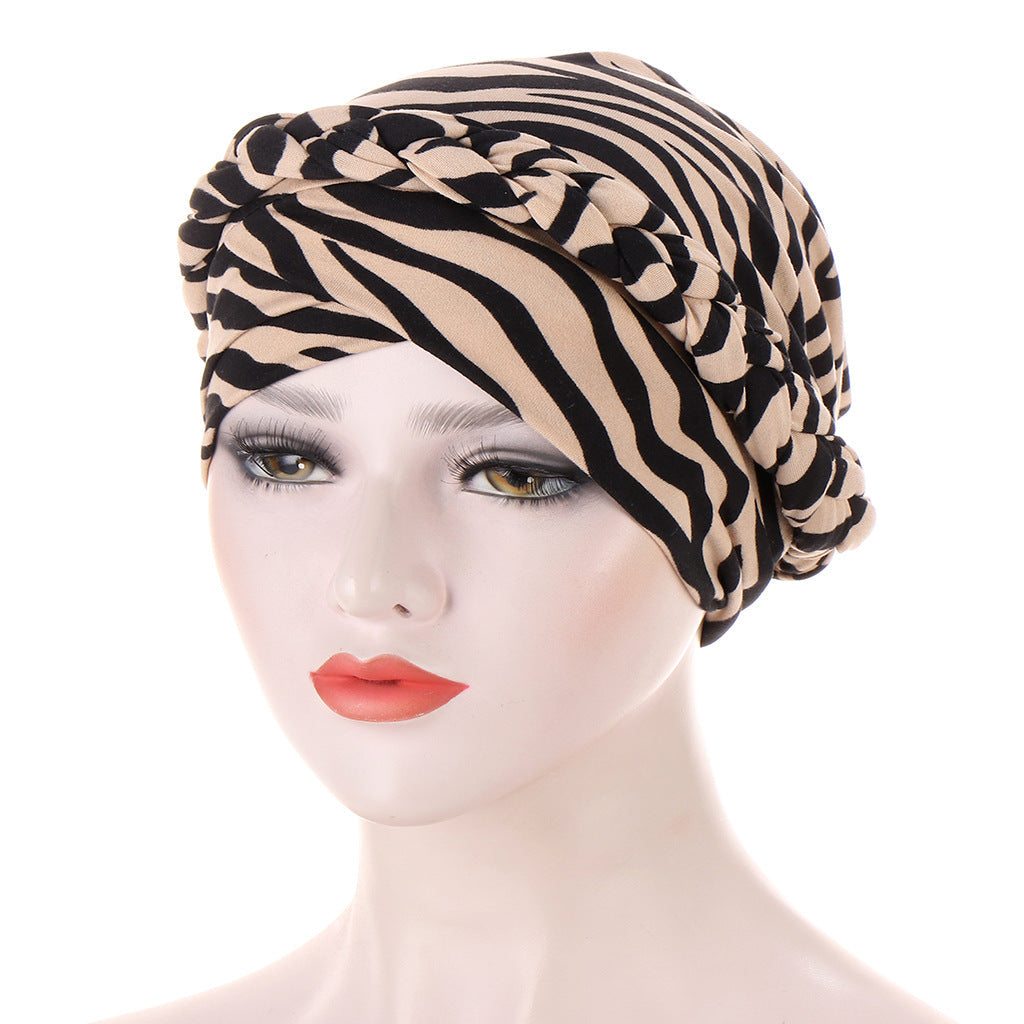 Headscarf cap in beige and black zebra-print polyester, featuring a braided trim; Short braids can be hidden beneath it.